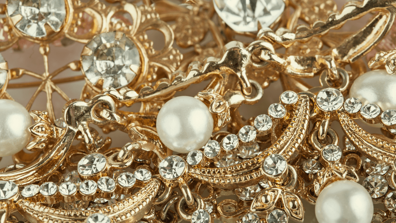 Macro detail of gold filigree set with crystals and stones.