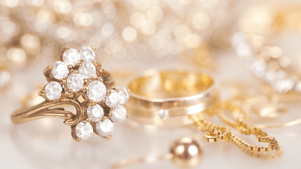 A gold cluster ring set with pavé stones, glittering against soft bokeh.